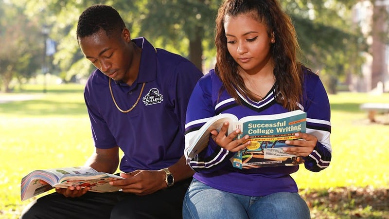 2 Paine College students reading outside on campus