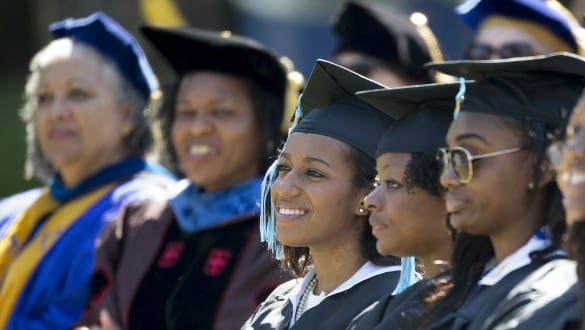 Graduating students and faculty from Spelman College wearing caps and gowns during graduation ceremony