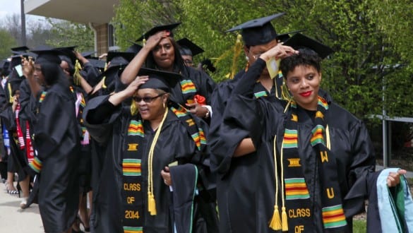 Group shot of Wilberforce University students wearing caps and gowns lined up for a graduation ceremony