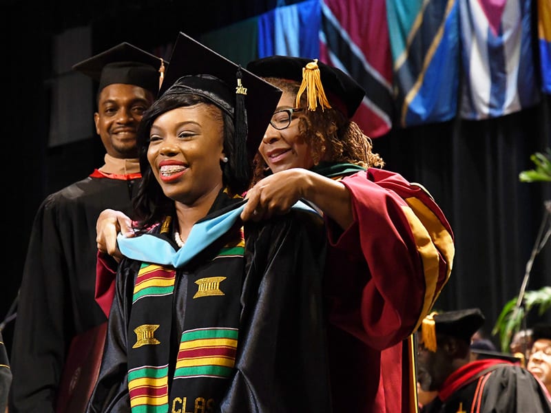 Female student receiving honors during college graduation ceremony at Bethune Cookman University