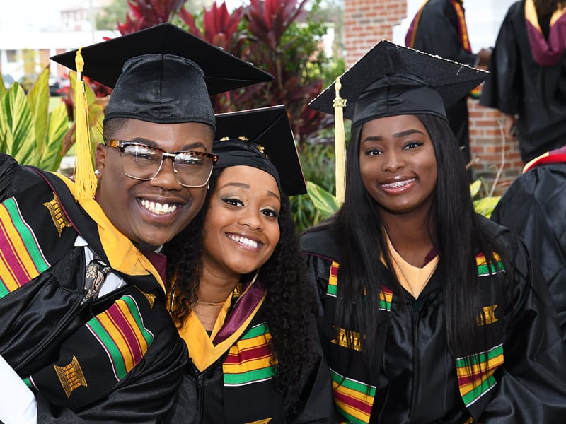 3 Bethune-Cookman University students in their caps and gowns