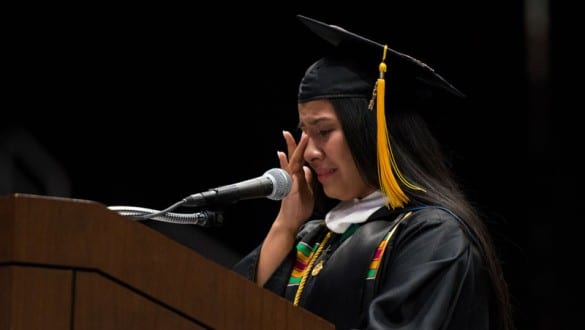 Female student giving emotional valedictory speech during Johnson C. Smith University graduation ceremony