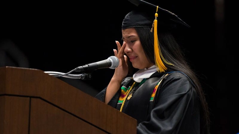 Female student giving emotional valedictory speech during Johnson C. Smith University graduation ceremony