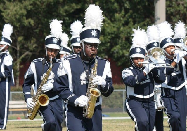 Group shot of Saint Augustine's University marching band members performing