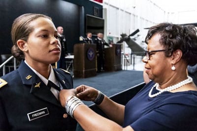 Retired Col. Christine Knighton pins aviator wings on 2nd Lt. Kayla Freeman at Freeman's graduation from the Army Aviation school, June 21, 2018, at Fort Rucker, Ala.