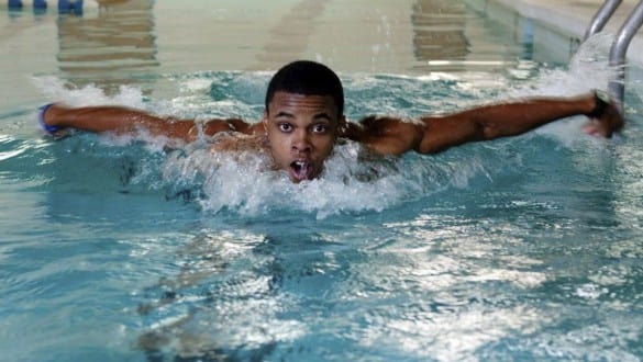 Male Voorhees College student swimming in lap pool