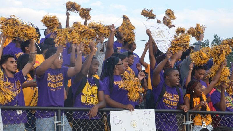 Miles College students cheering during game with pompoms