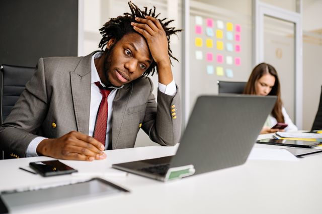 African American student experiencing stress while working on a laptop indoors. Photo from Pexels/Yan Krukau.