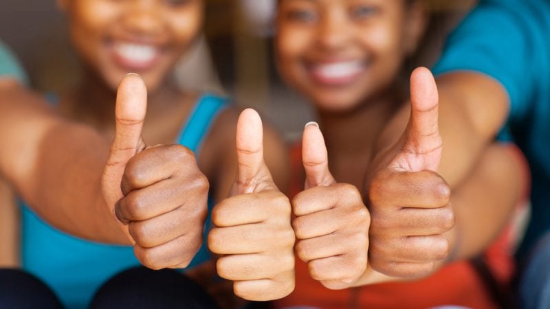 4 students with thumbs up