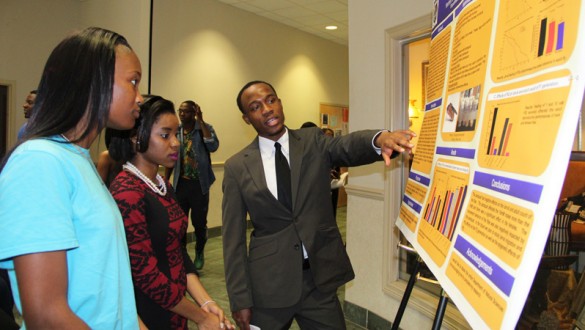 Students talking in front of statistical presentation board at Stillman College