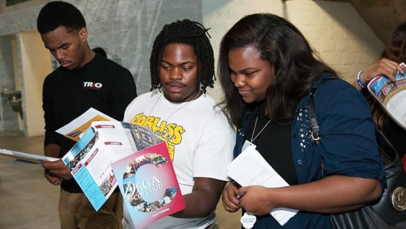 Headshot of students looking at brochures