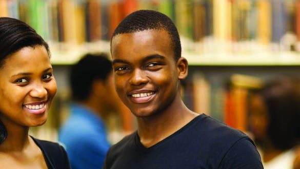 Photo of two African American students in library