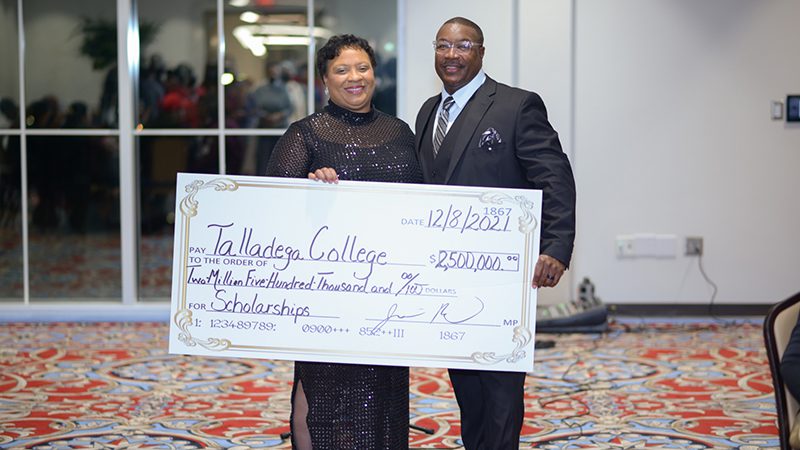 Talladega President Dr. Long and an associate hold the donation check for $2.5 Million