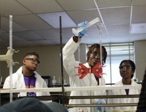 Three people in Texas College laboratory setting