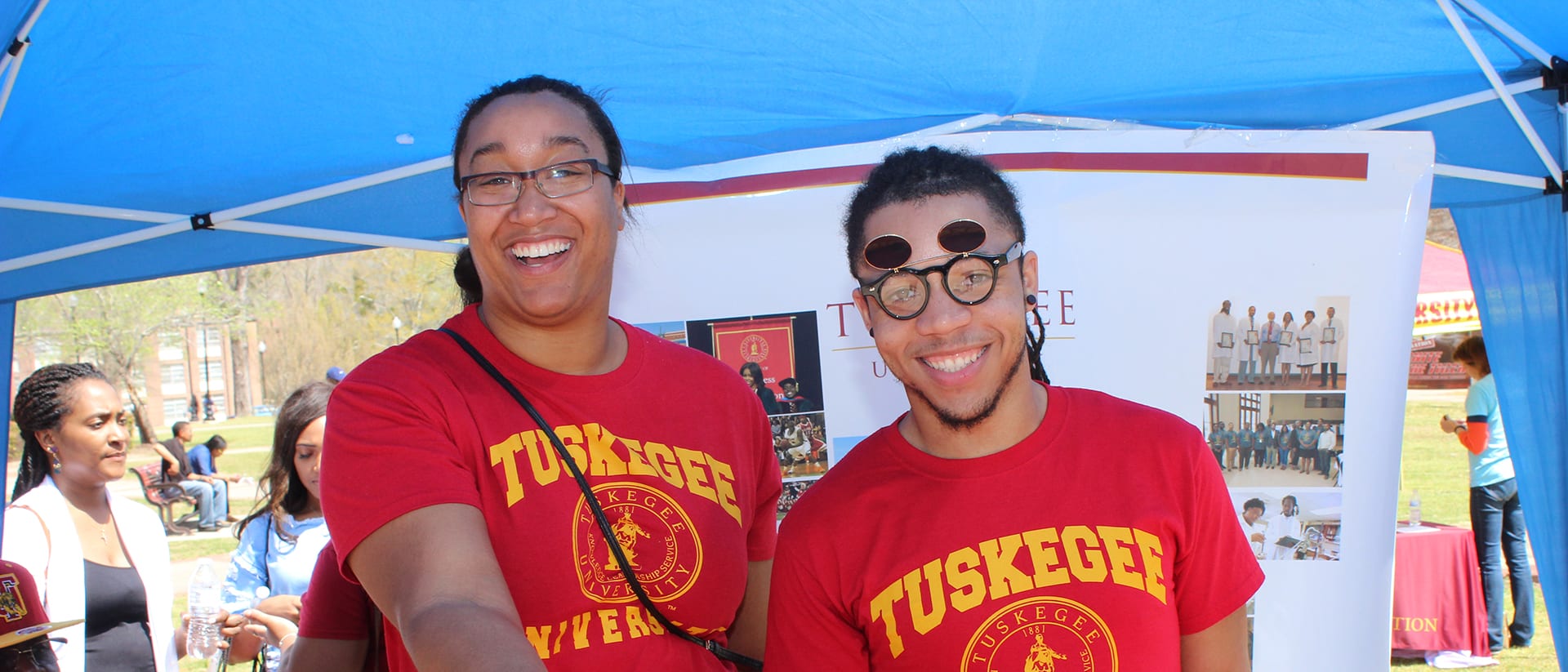 Tuskegee students under tent at open house event