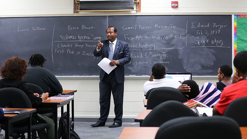 A professor lectures in front of his whiteboard at Virginia Union University