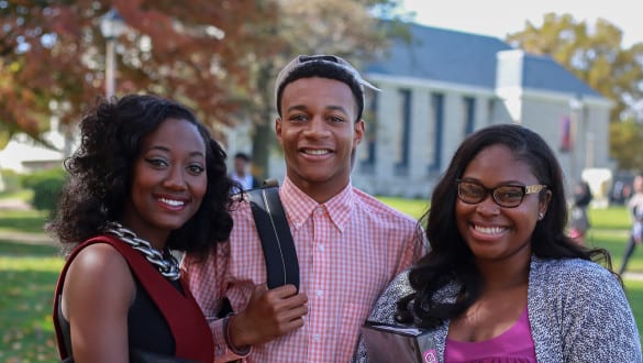 Virginia Union students smiling at the camera outside campus building