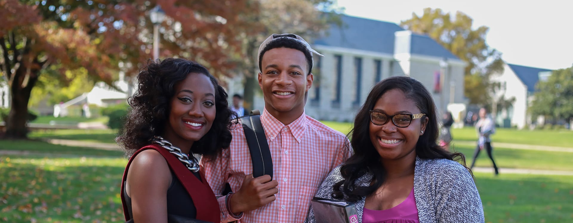 Virginia Union students smiling at the camera outside campus building