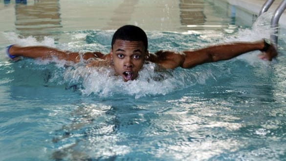 Male Voorhees College student swimming in lap pool