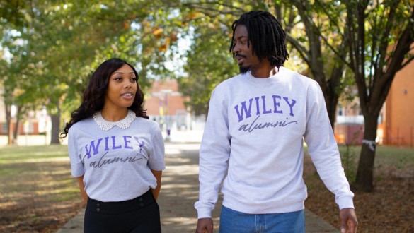2 Wiley College alumni walking and talking outside on campus